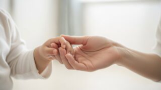 幼児の爪のケアをする親